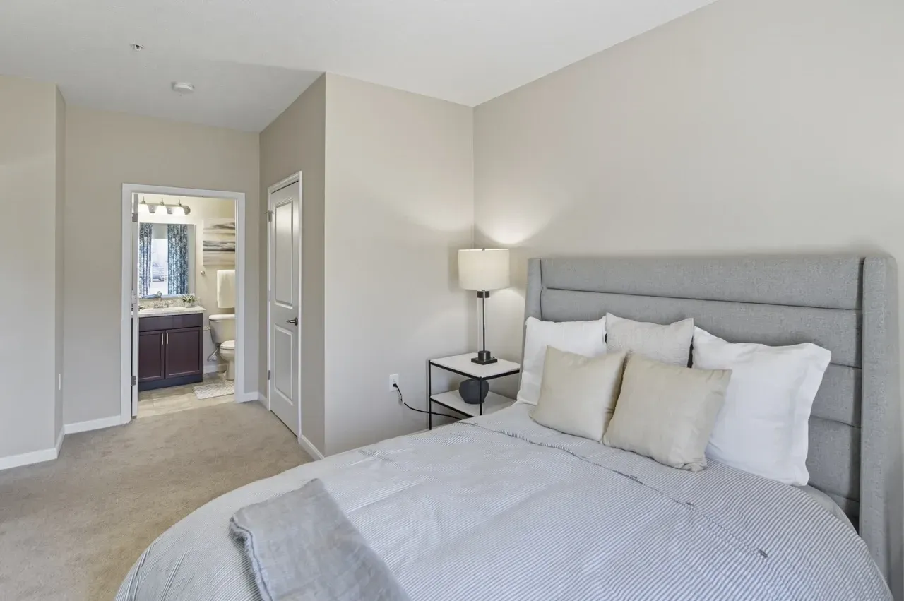 Bedroom with a king-size bed and a view of the bathroom.