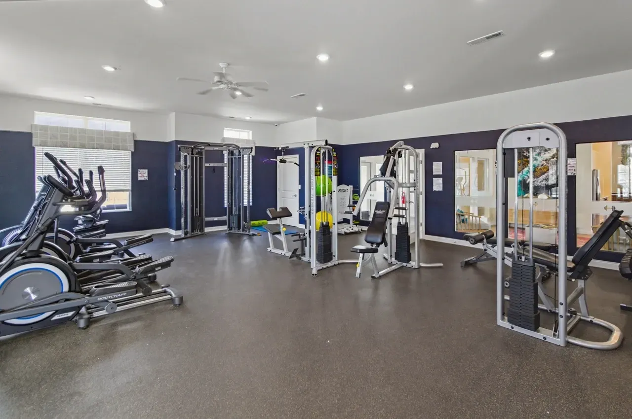 Fitness center with cardio and weight machines.