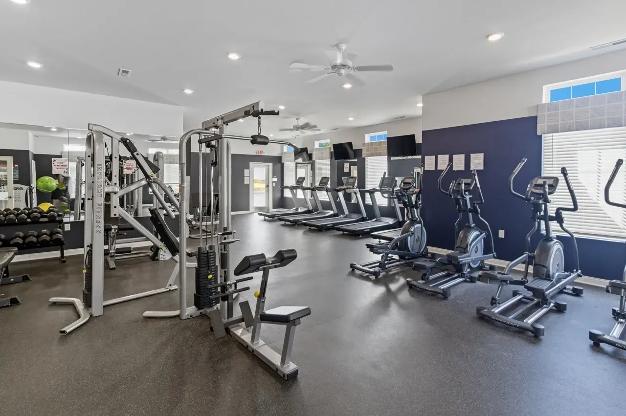 Fitness center with treadmills, ellipticals, and weight machines.