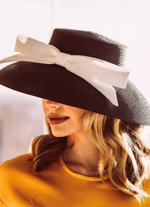 woman with black hat with white bow