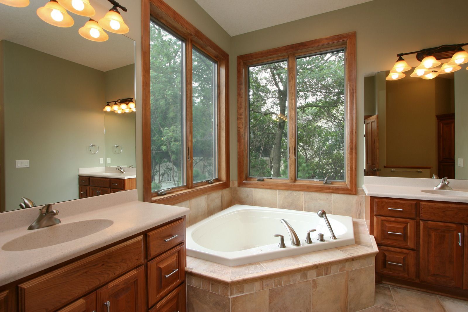 A kitchen with white cabinets , a sink , and a window.