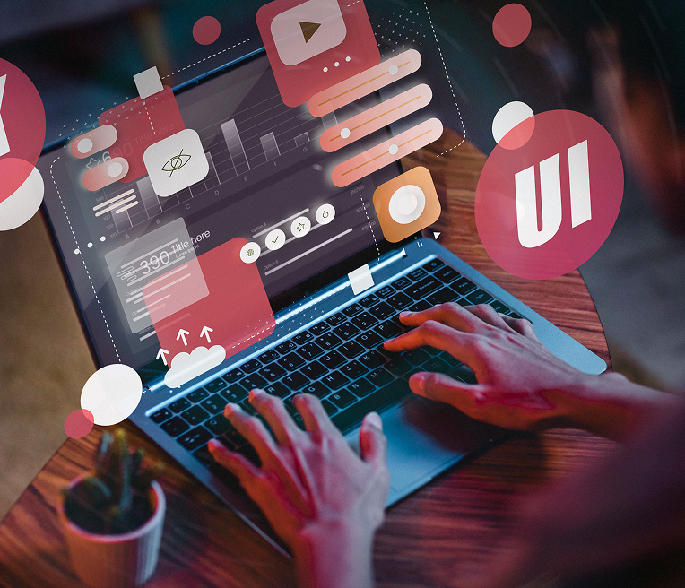 Person using a laptop with UI design elements floating above the screen, red and white color scheme.