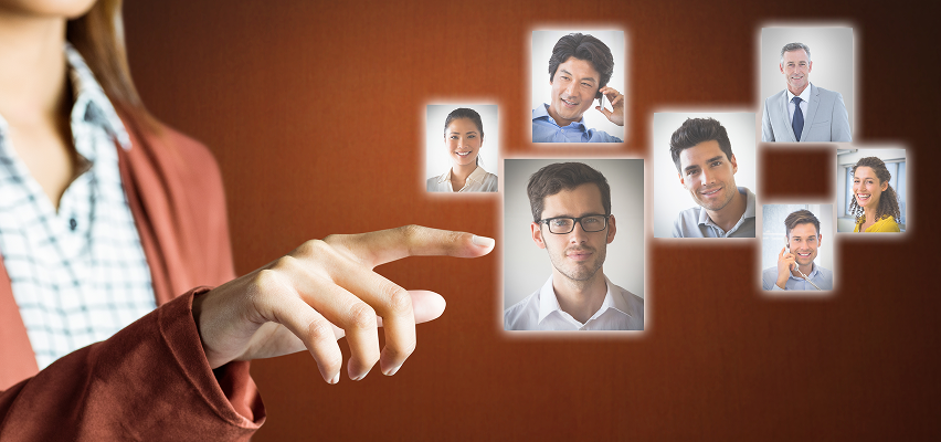 Woman's finger pointing towards a screen with floating headshots of various people.