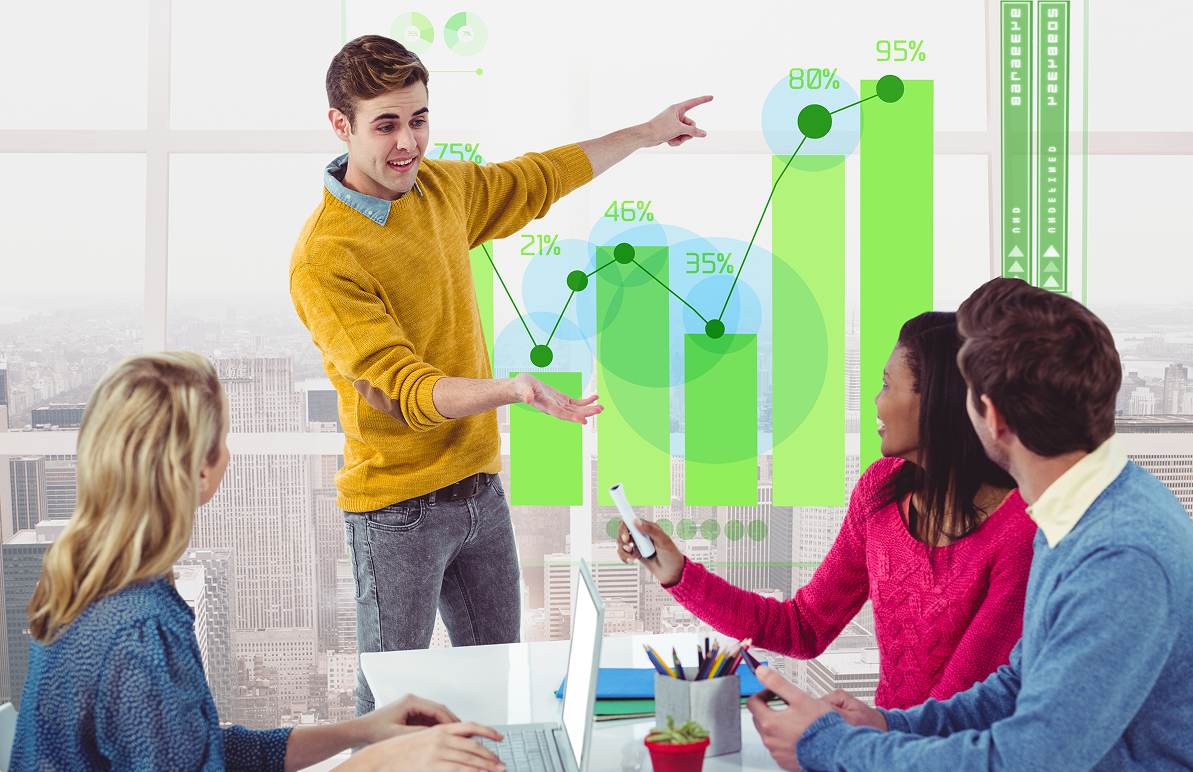 Man with beard in blue plaid shirt filming a video in a home studio. Camera and lamp in foreground.