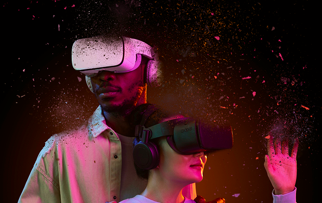 Man and woman wearing VR headsets, amid colorful dust particles, dark background.