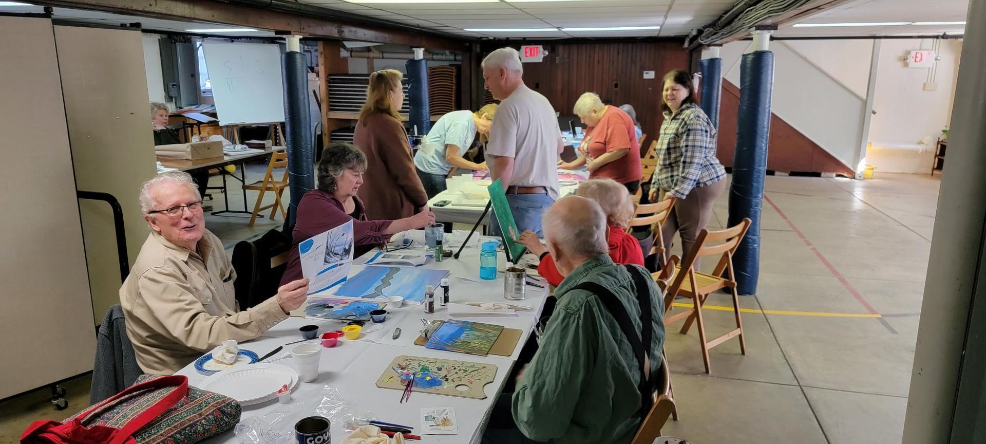 A group of people are sitting around a table in a room.
