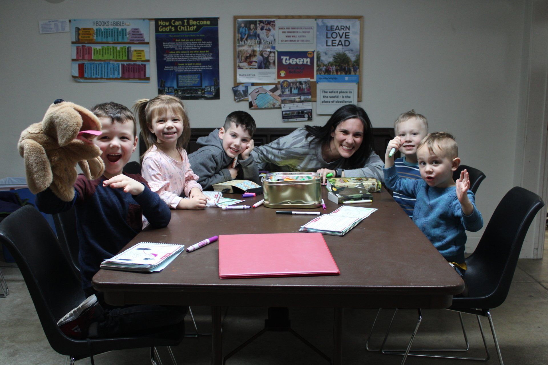 A group of children are sitting around a table.
