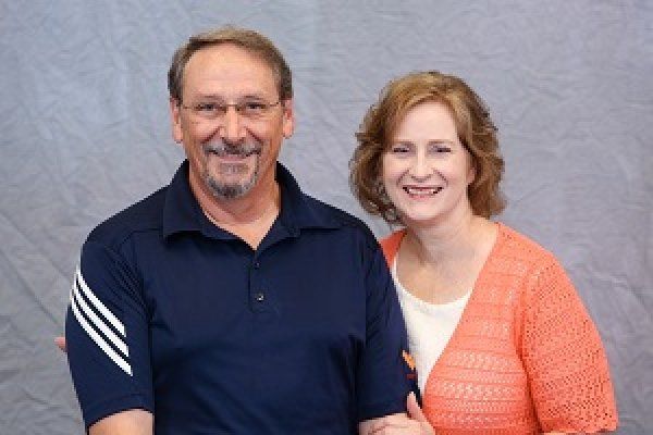 A man and a woman are posing for a picture together.