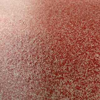 Primo piano della superficie rossa testurizzata con polvere bianca punteggiata.