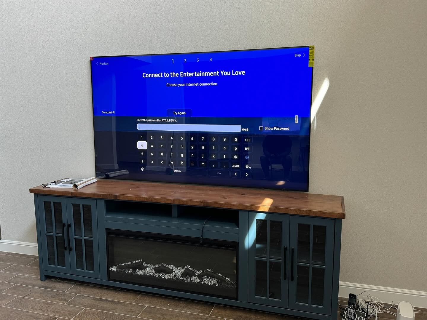 A flat screen tv is sitting on top of a wooden entertainment center.