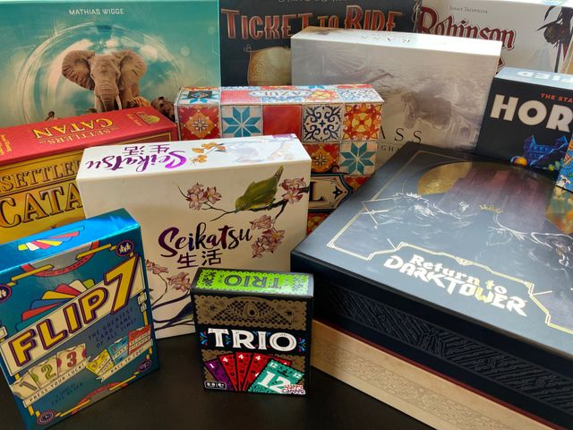 Photo: a collection of board games, all safely tucked away in their boxes and arranged nicely in frame