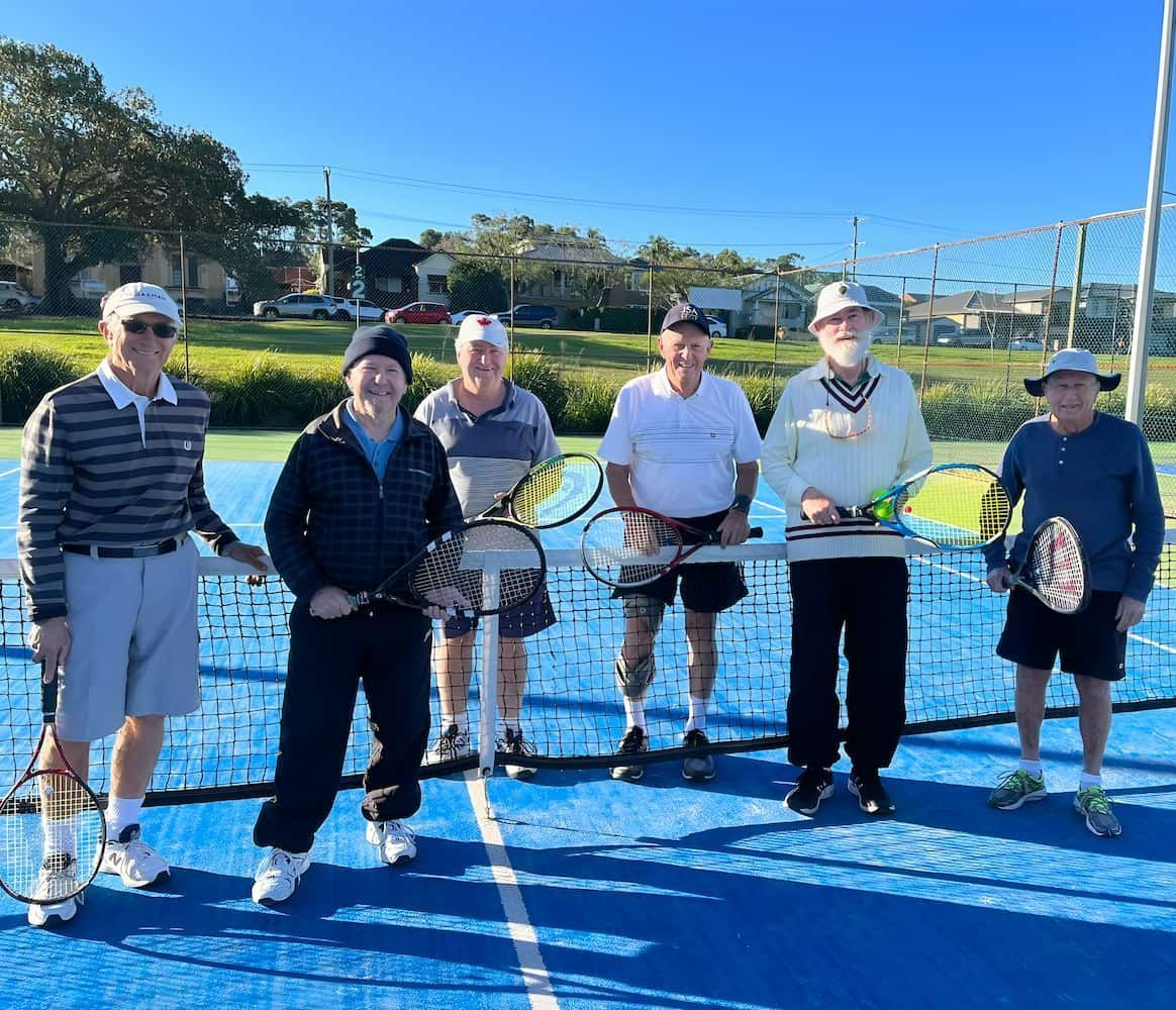 A Group of Men Standing on a Tennis Court Holding Tennis Rackets — Topspin Tennis Newcastle in Lambton, NSW