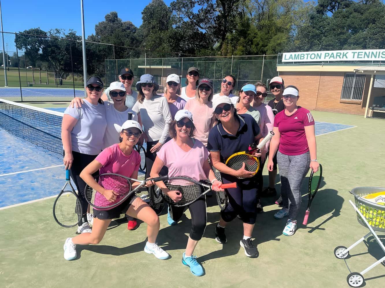 A Group of Women Are Posing for a Picture on a Tennis Court — Topspin Tennis Newcastle in Lambton, NSW