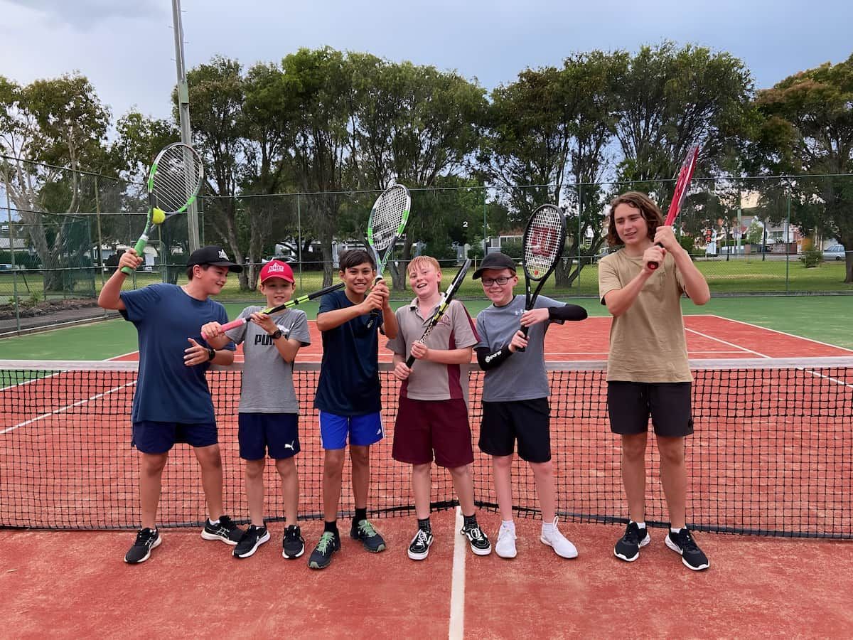 A Group of Young Boys Are Standing on a Tennis Court Holding Tennis Rackets — Topspin Tennis Newcastle in Lambton, NSW