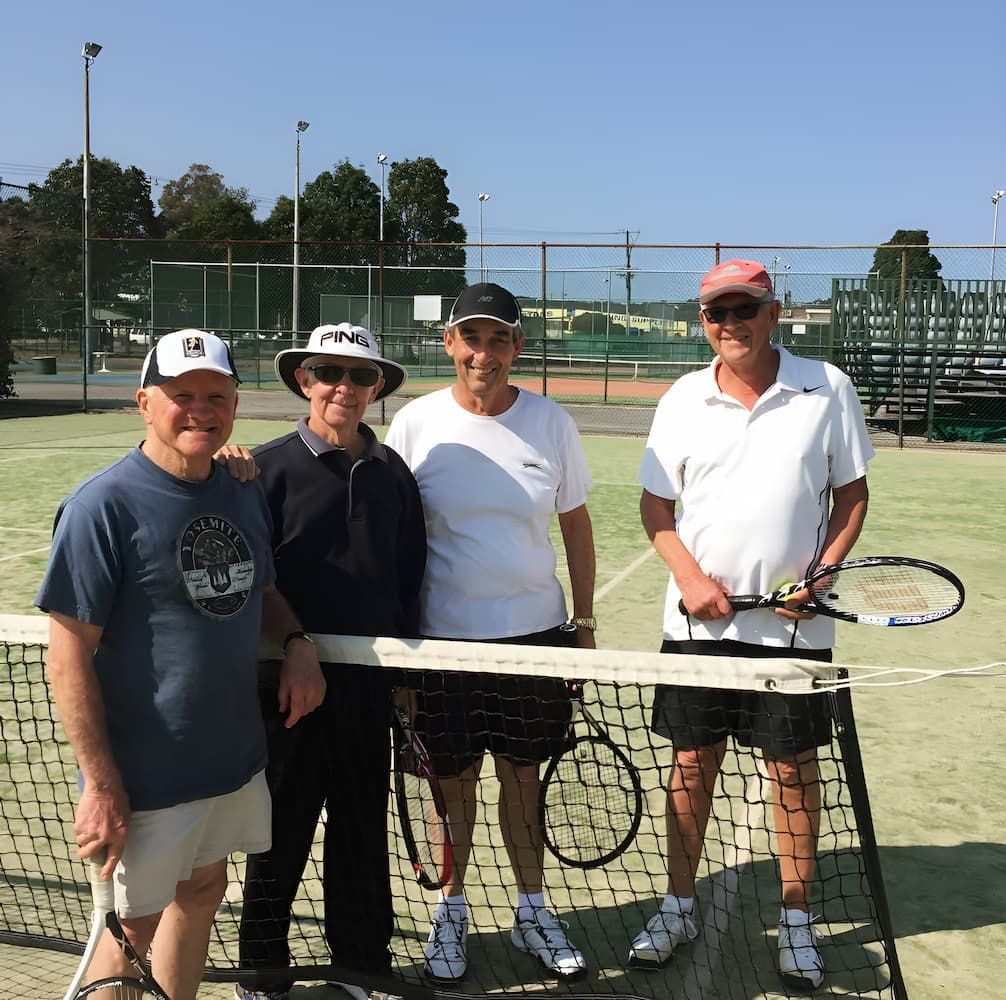 A Group of Men Are Standing on a Tennis Court Holding Tennis Rackets — Topspin Tennis Newcastle in Lambton, NSW