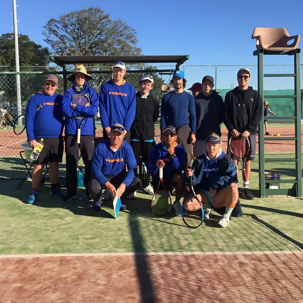 A Group of Men Are Posing for a Picture on a Tennis Court — Topspin Tennis Newcastle in Lambton, NSW