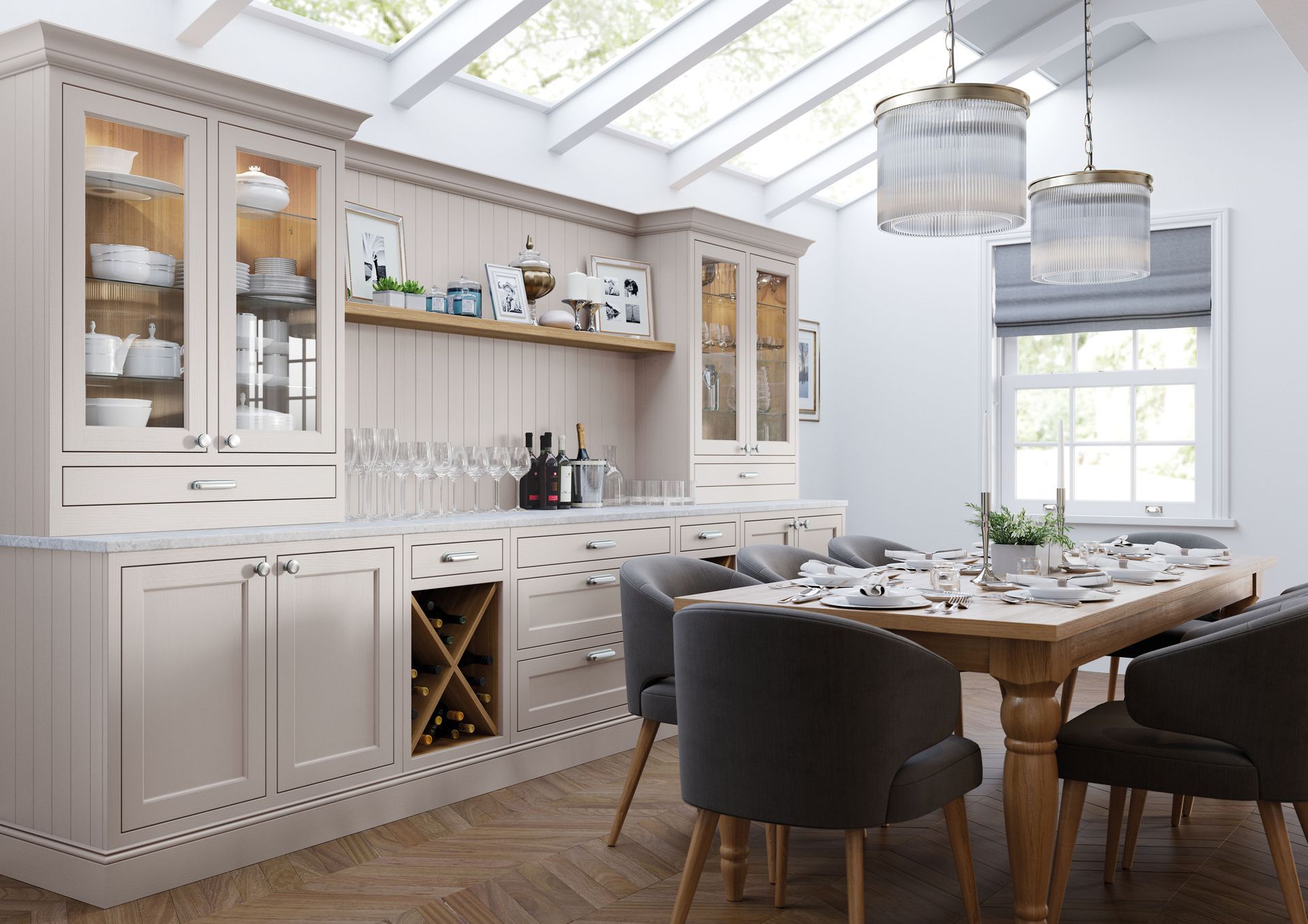 Modern open-plan kitchen and dining area with cream cabinetry, a central island, and a circular wooden dining table.