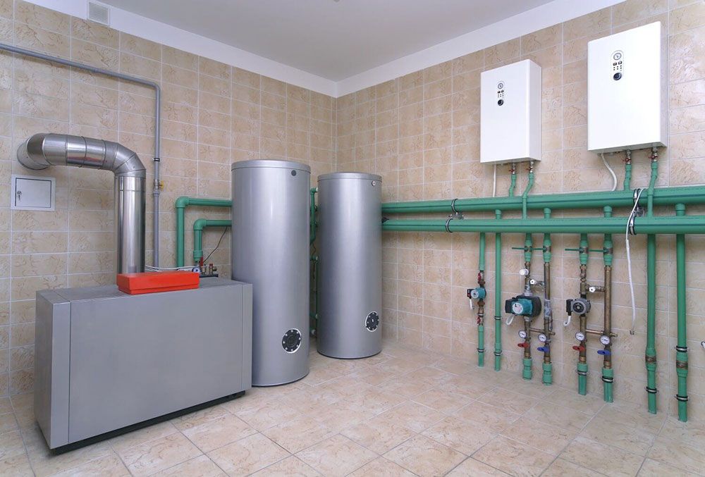 A Room With A Lot Of Pipes And A Boiler — Tim Larkin Plumbing and Excavations in Laurieton, NSW