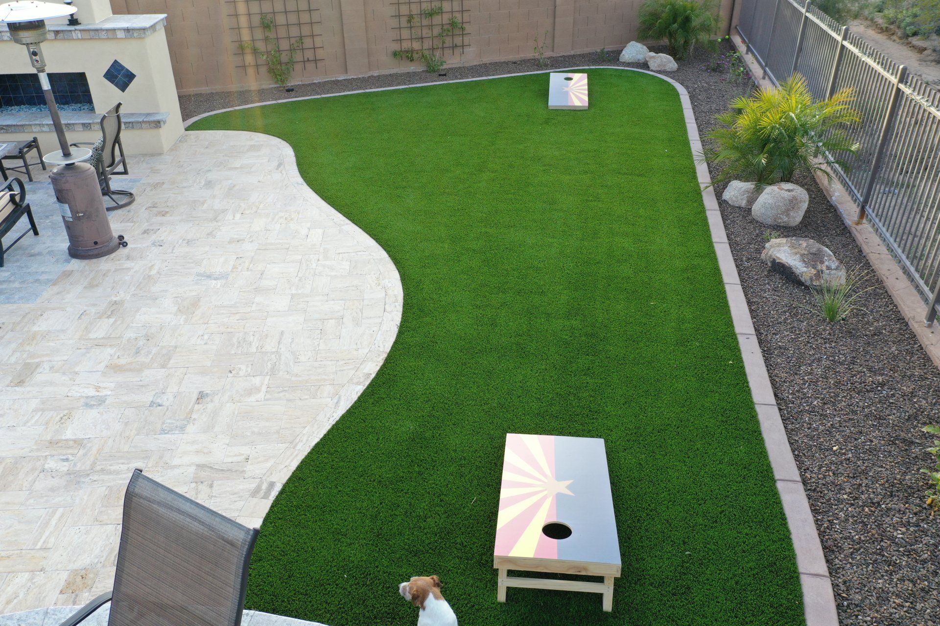 backyard patio made of pavers and artificial grass