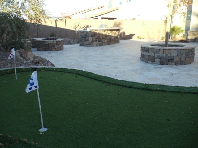 You get a pro-level ball roll, personalized features, and the well-kept aesthetics of a golf range without having to spend a lot of time and money on lawn maintenance with this backyard putting green in Tempe, AZ.