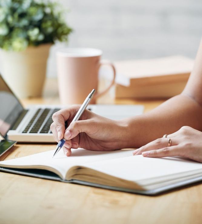 Woman writing in a notebook