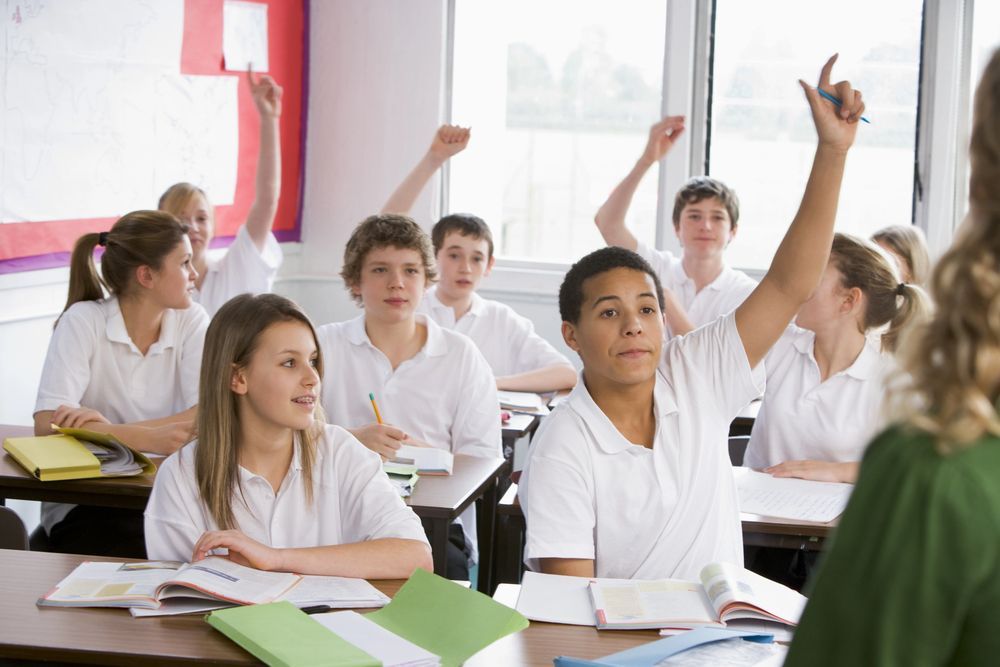 Young girl being taught by a teacher