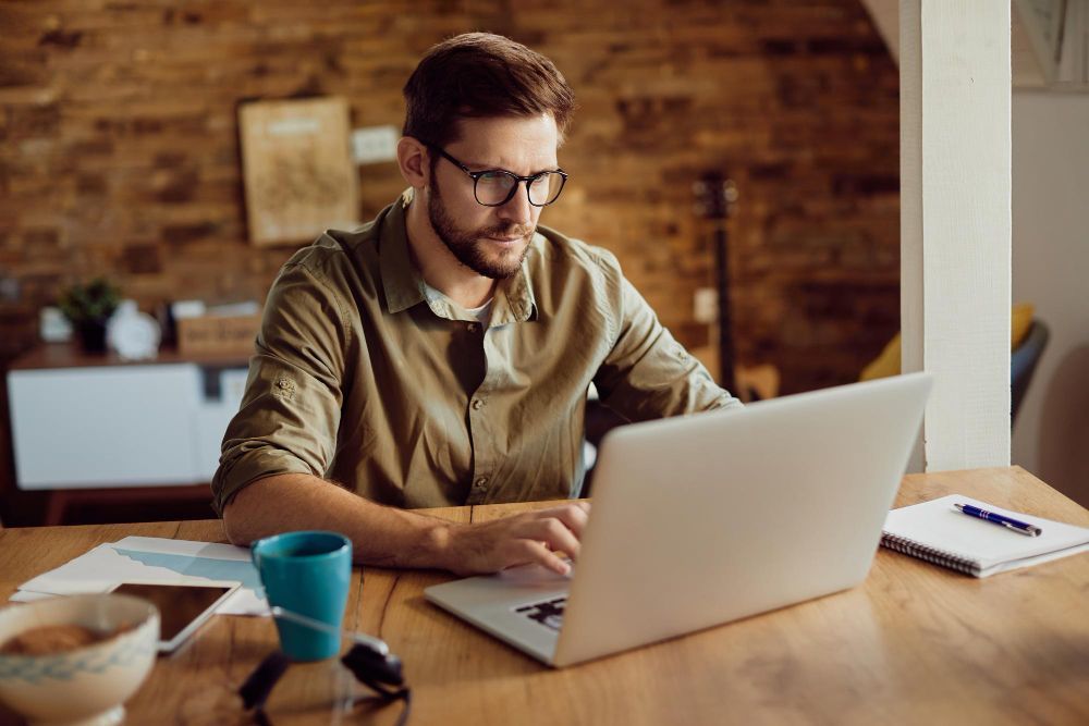 man researching on his computer