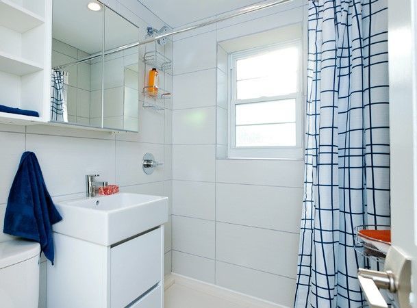 A bathroom with a sink and a shower curtain