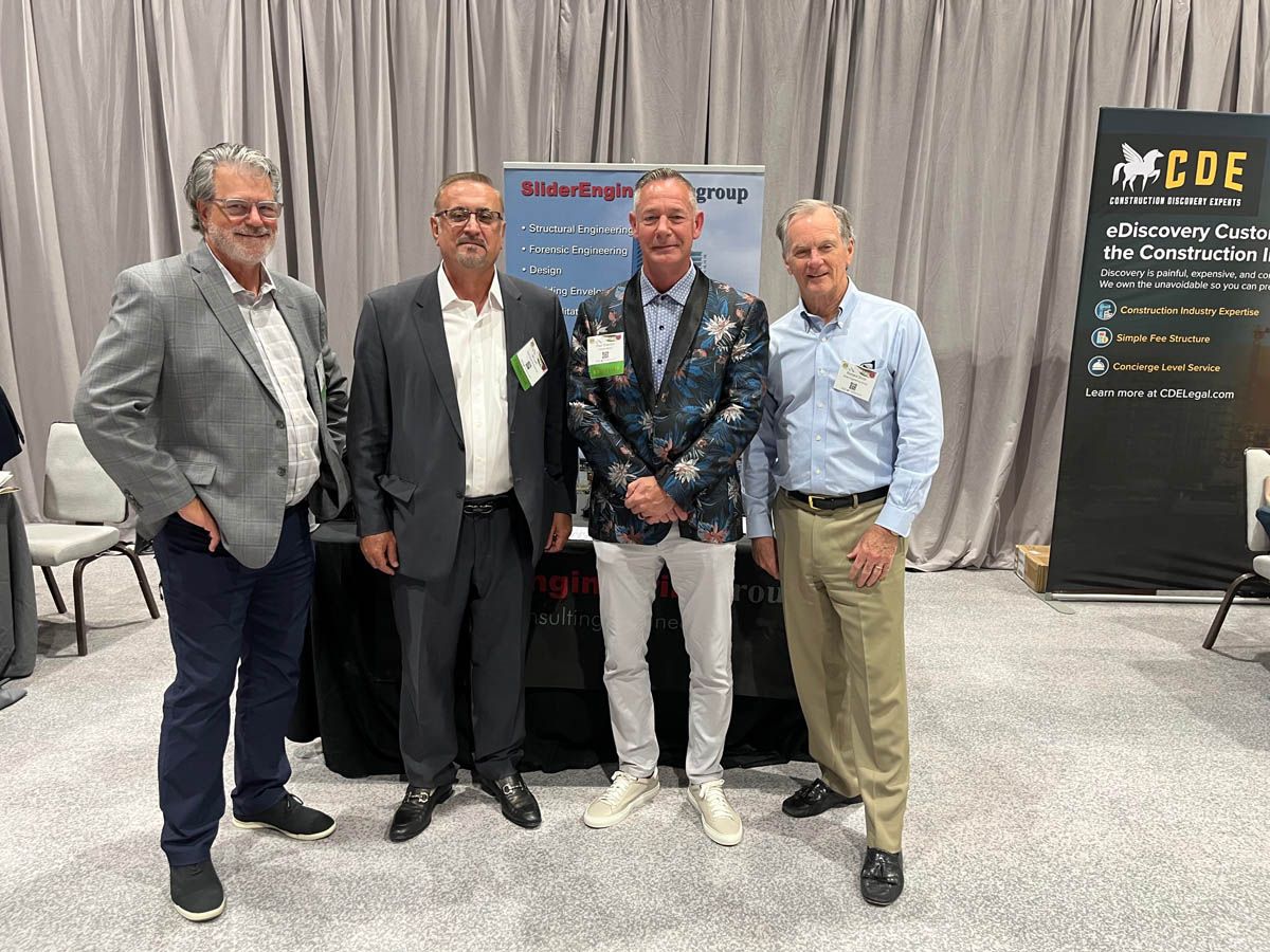 A group of men are standing next to each other in a room.