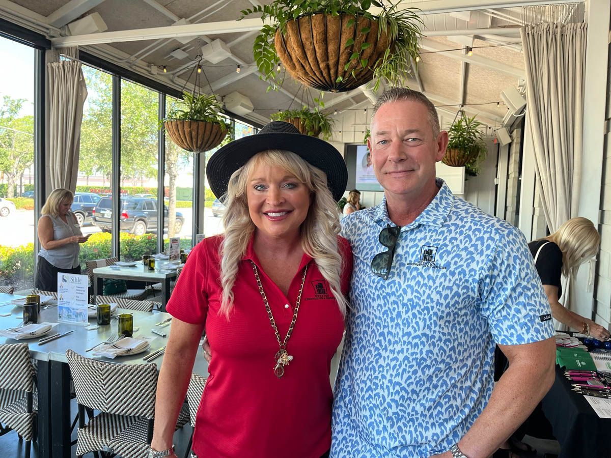 A man and a woman are posing for a picture in a restaurant.