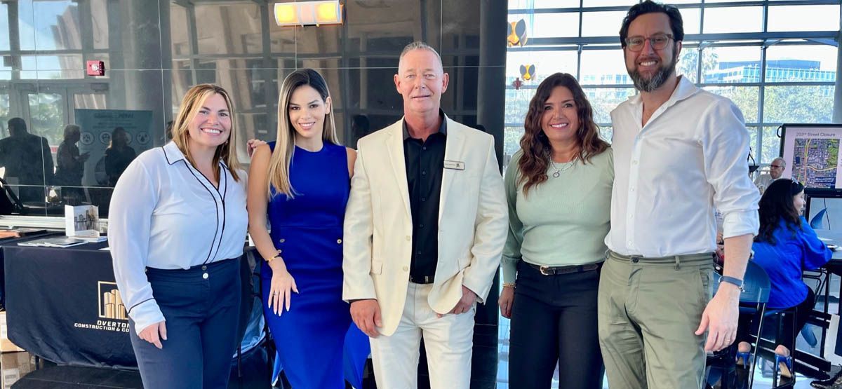 A group of people are posing for a picture in an office.