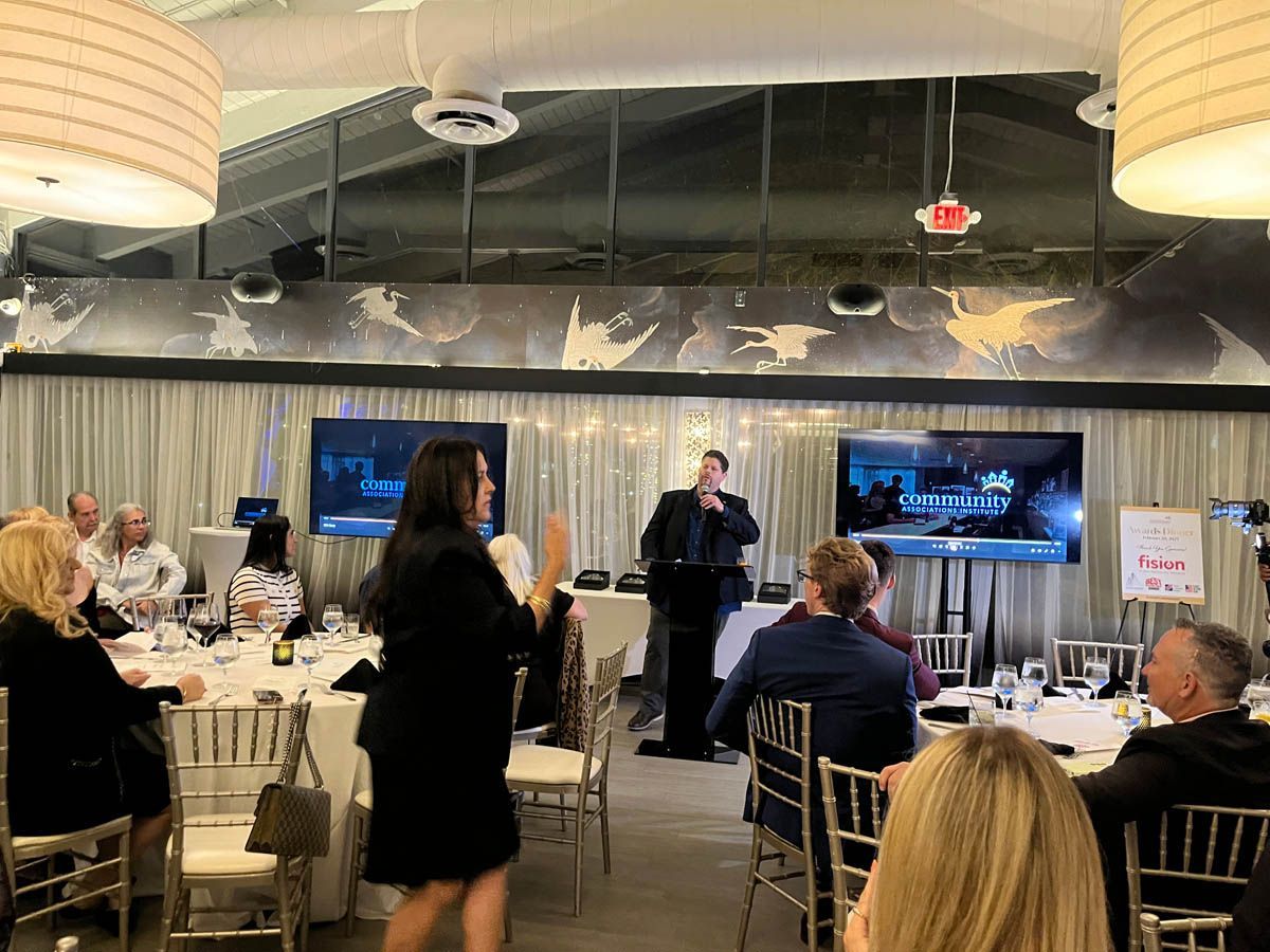 A group of people are sitting at tables in a room.