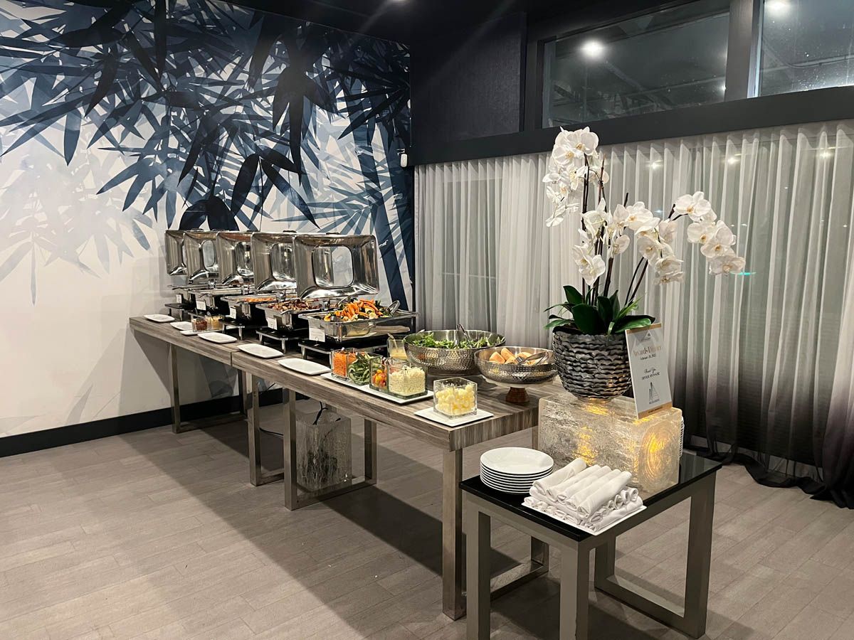 A long table with a variety of food on it in a room.