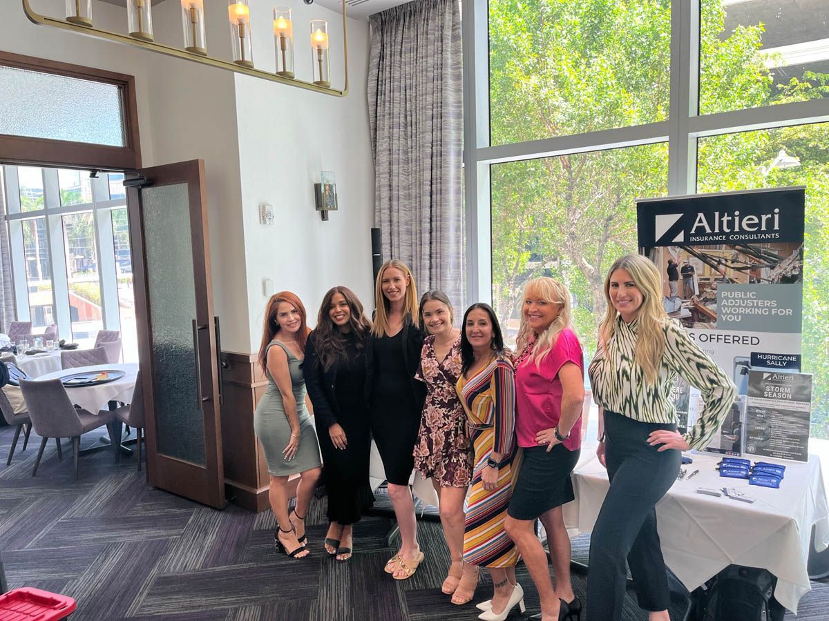 A group of women are posing for a picture in a room.