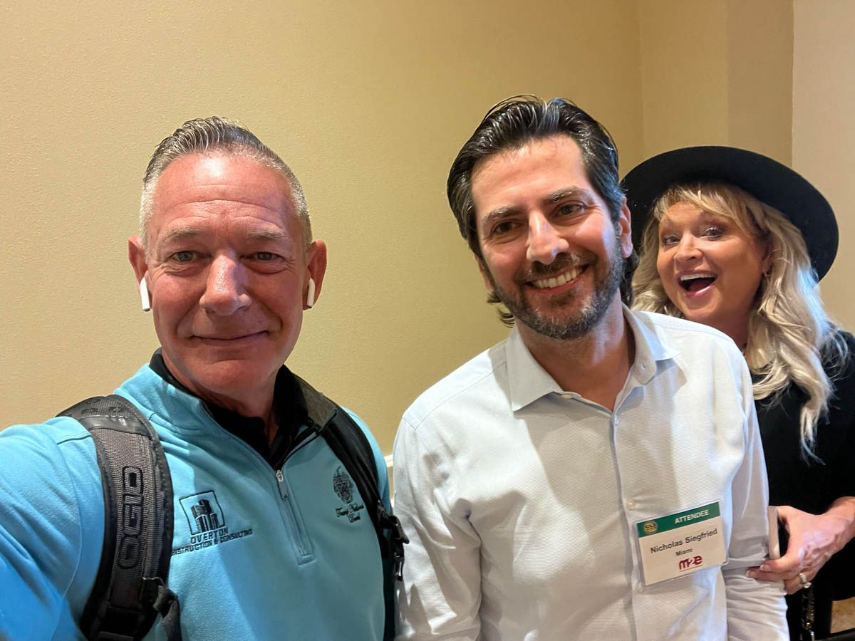 A group of people are posing for a picture in a room.