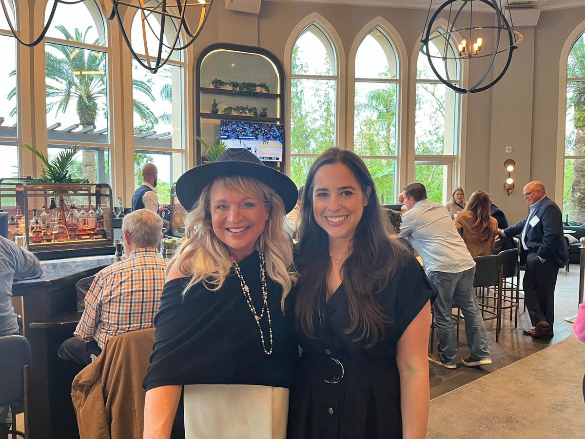Two women are posing for a picture in a restaurant.