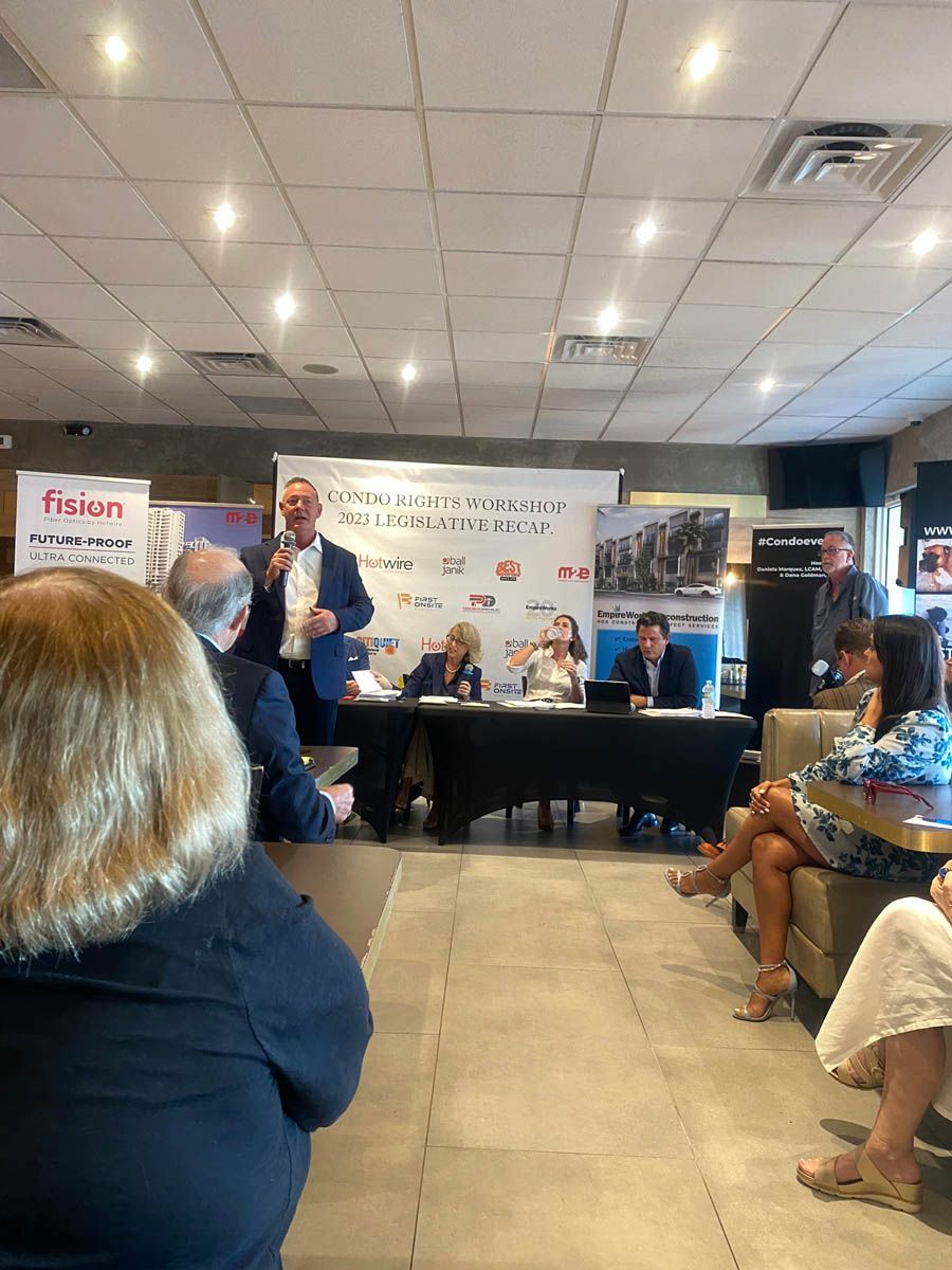 A group of people are sitting at tables in a room.