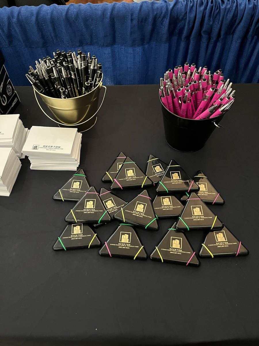 A table with a bunch of pens and cards on it