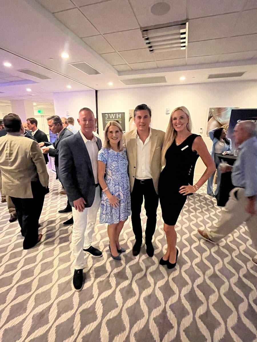 A group of people are posing for a picture in a room.
