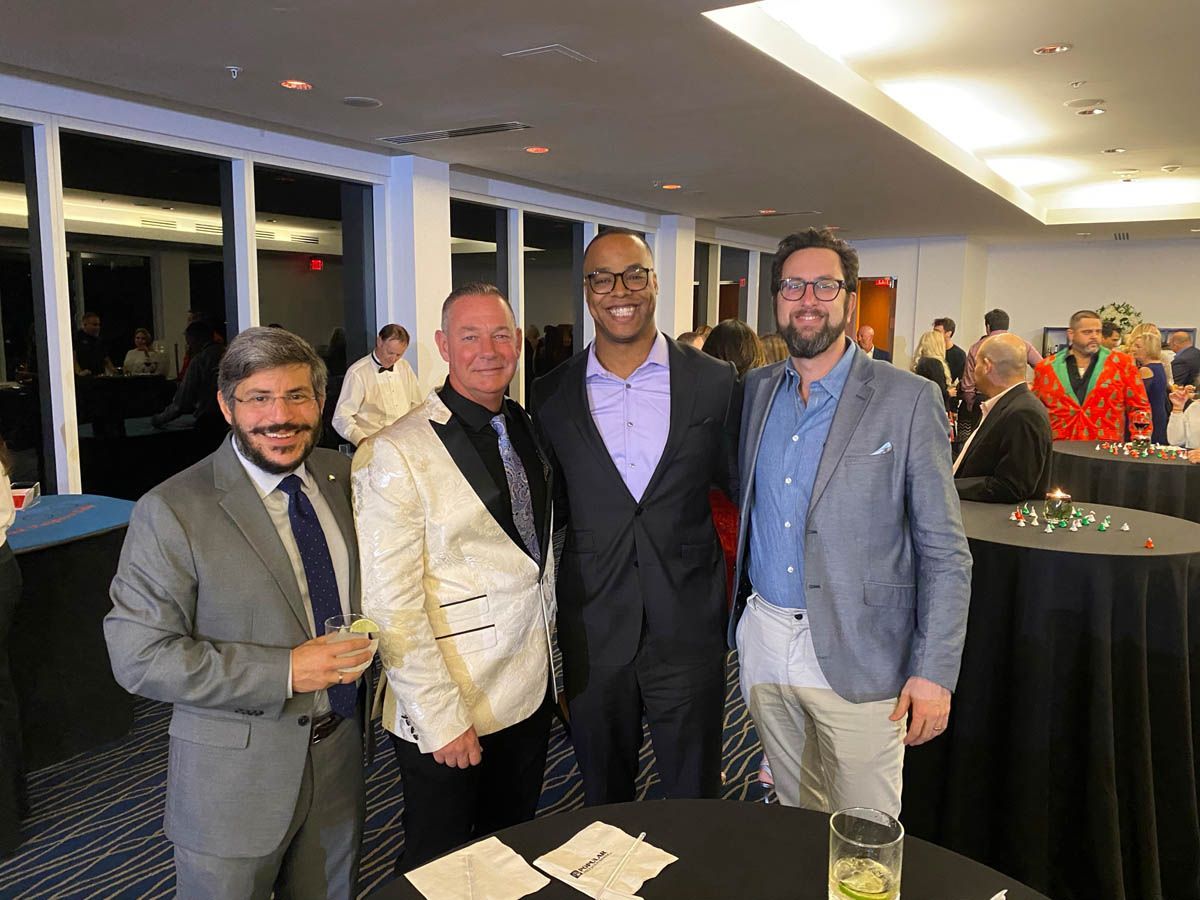 A group of men are posing for a picture in a room.