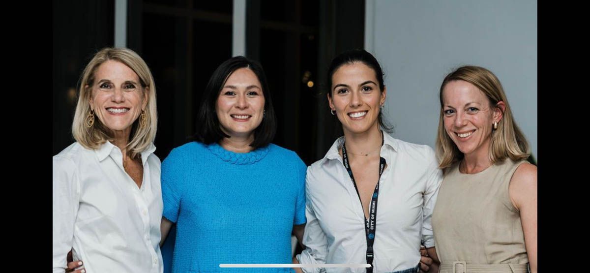 A group of women are posing for a picture together.