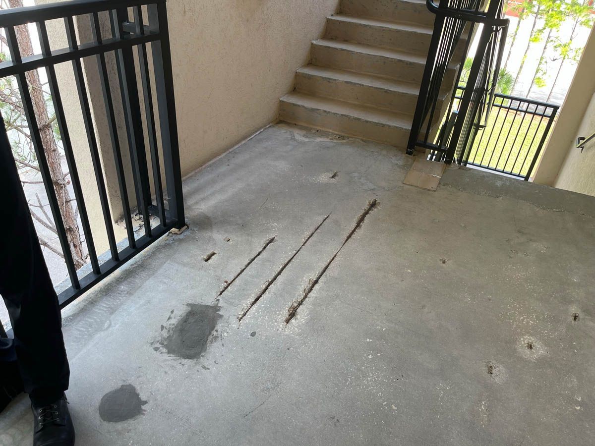 A person standing next to a staircase with a railing
