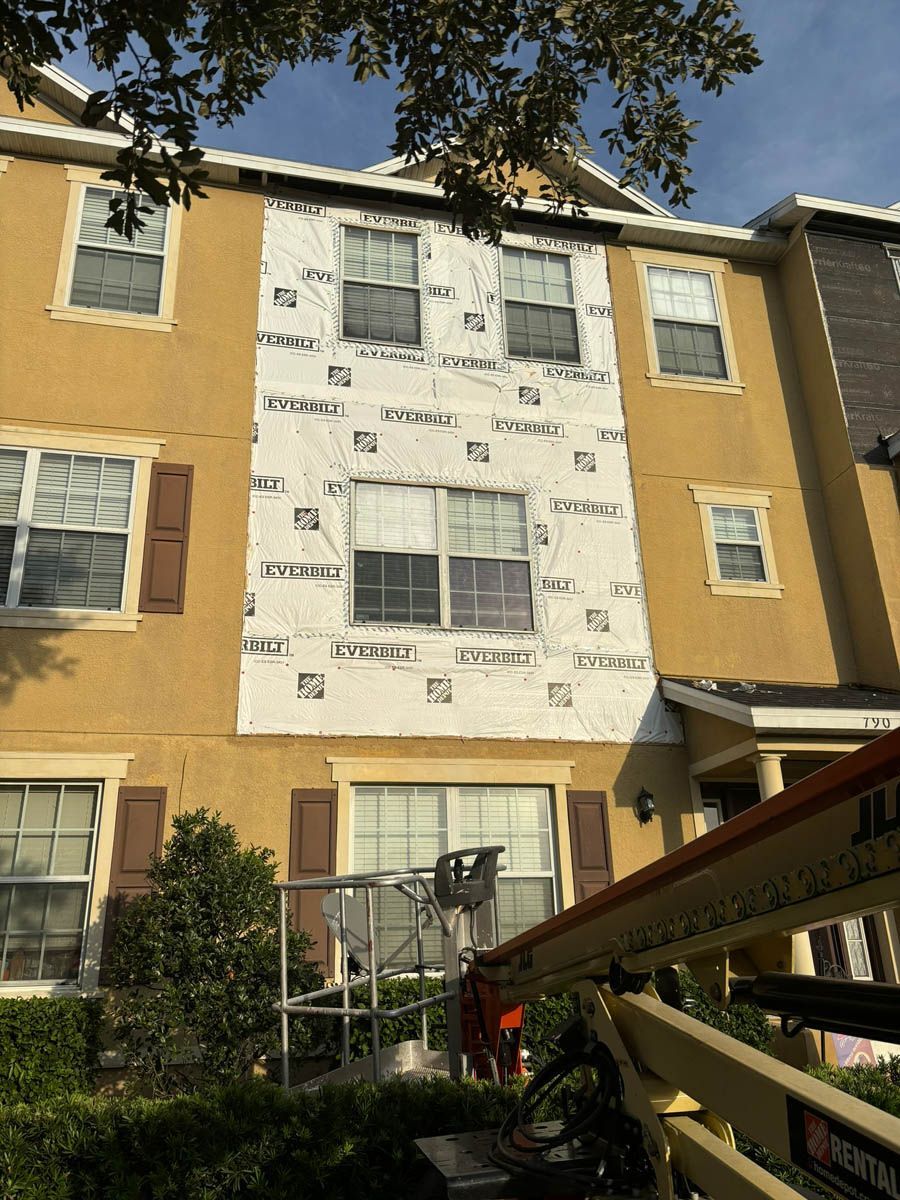 A building with a lot of windows is being remodeled.