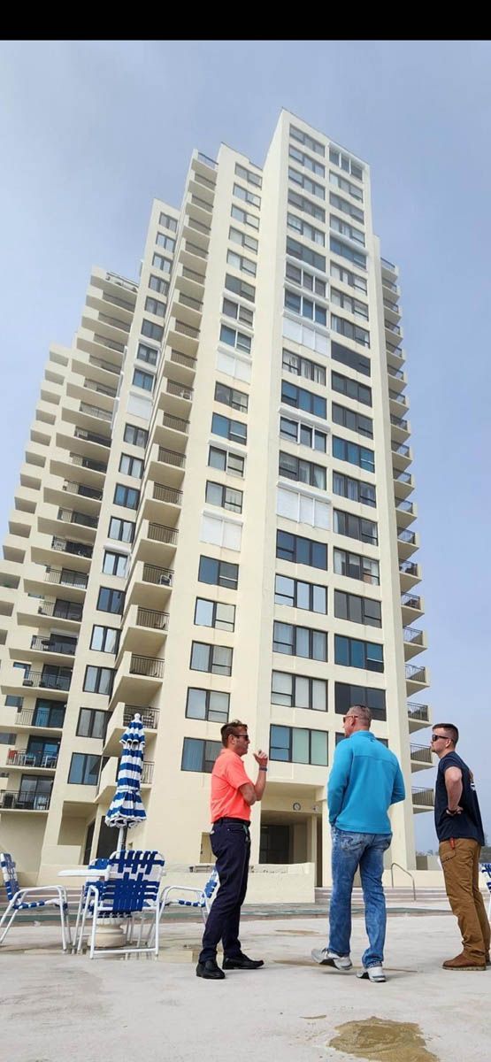 A group of people are standing in front of a tall building.