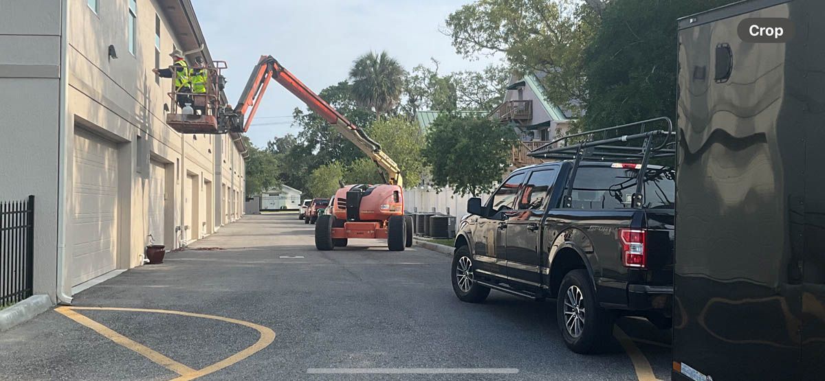 A truck is parked in a parking lot next to a building.