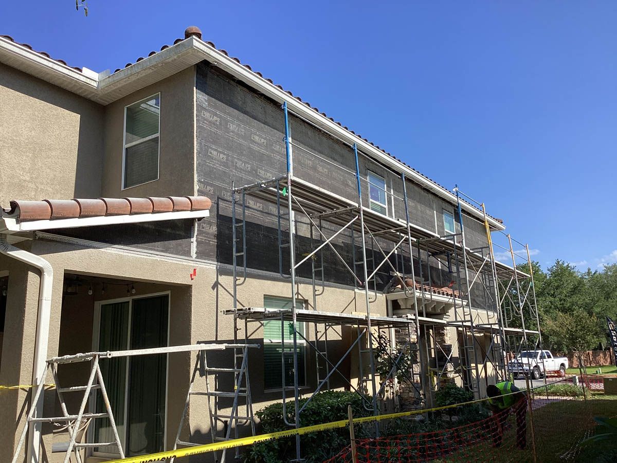 A house is being remodeled with scaffolding on the side of it.