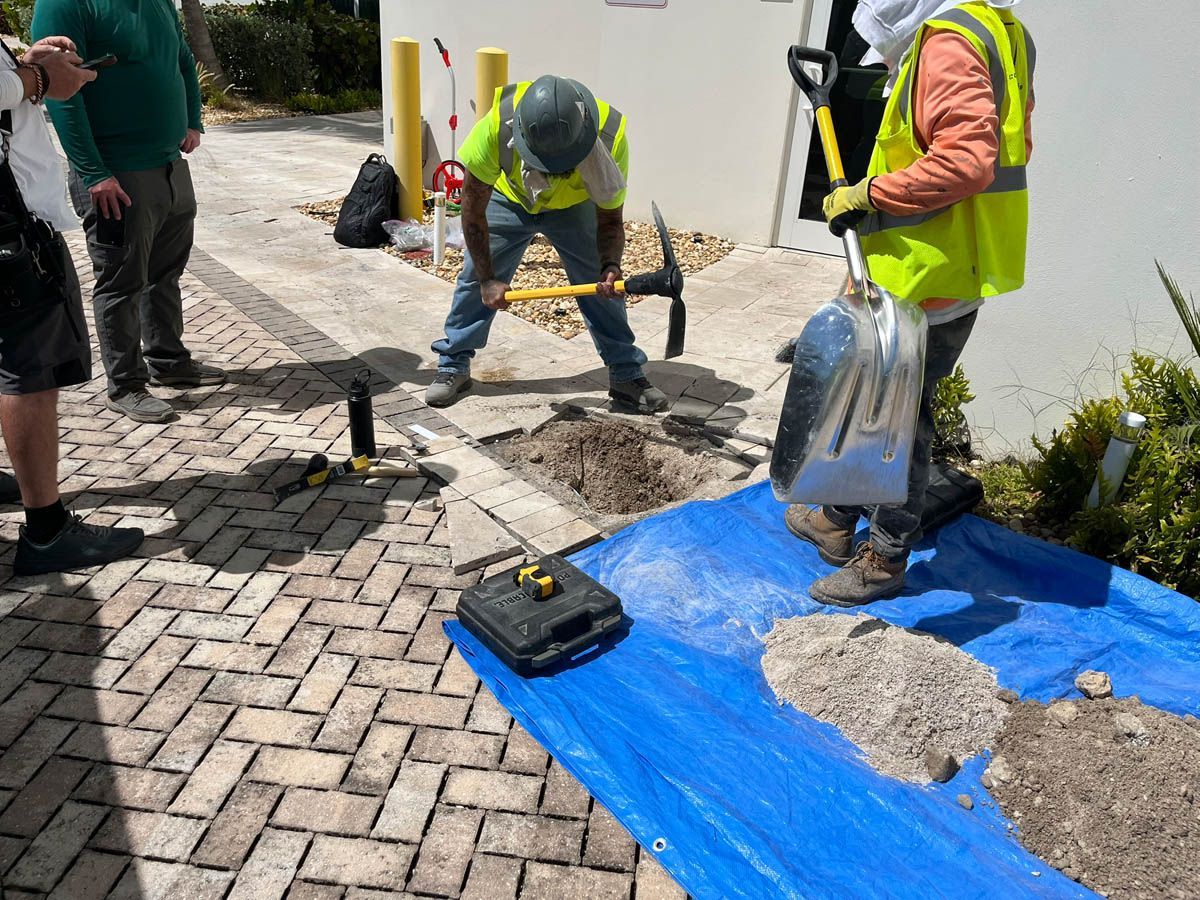 A group of construction workers are working on a blue tarp.