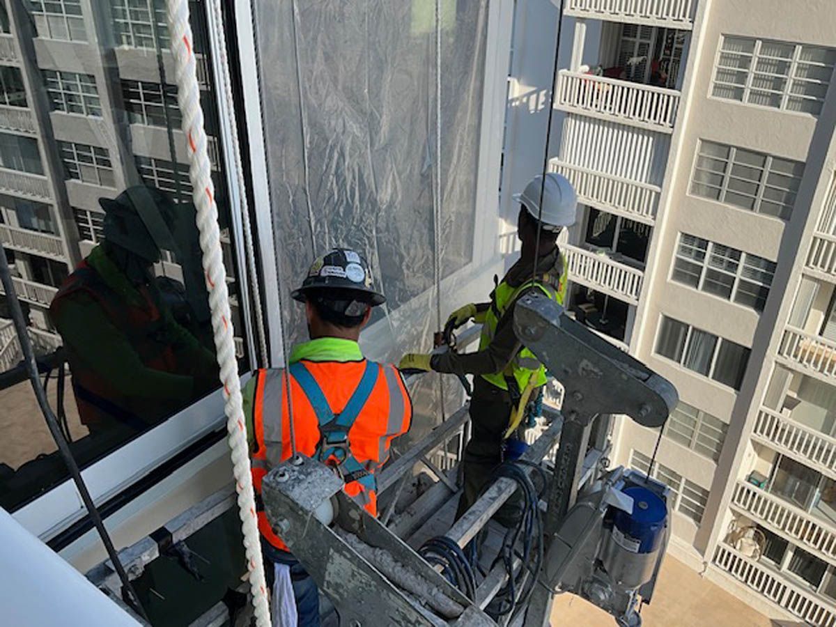 A group of construction workers are working on a building.