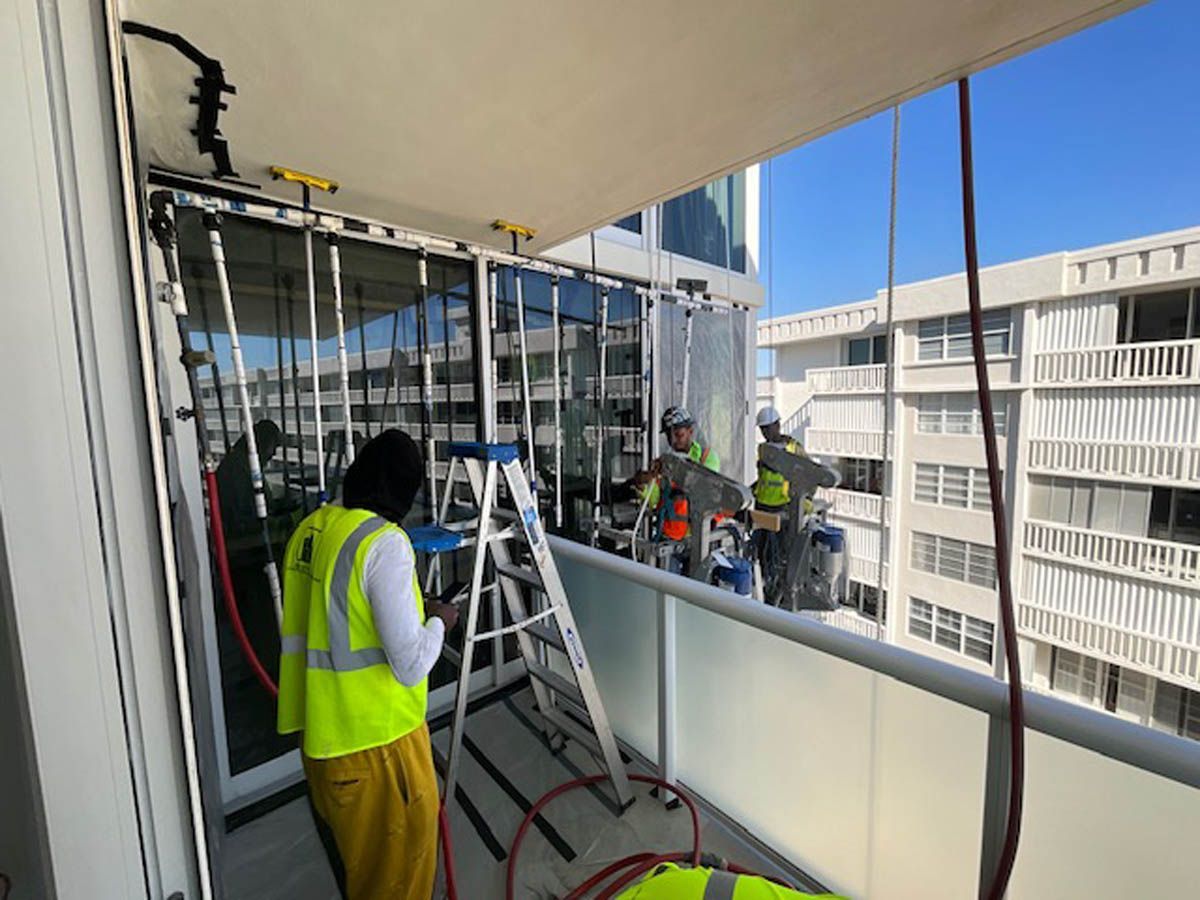A group of people are working on a balcony.