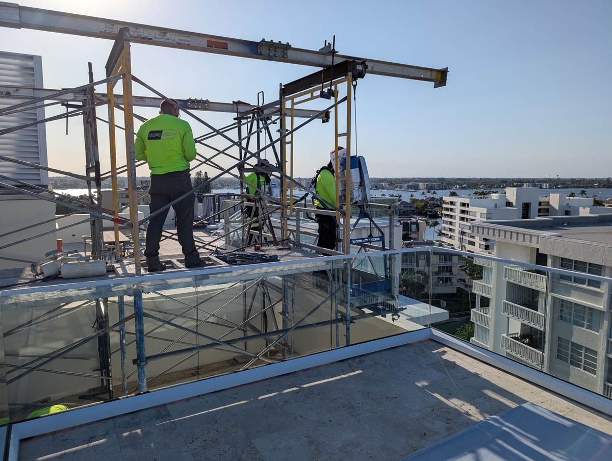 A group of construction workers are working on the roof of a building.